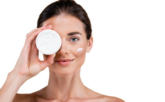 woman holding cream by her eye